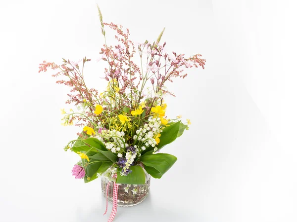 Beautiful bouquet of bright wild flowers and lily isolated on white