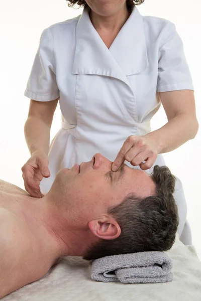 Facial and cranial osteopathy therapy given by a female