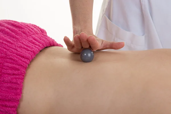 Spa massage with stone ball at beauty center