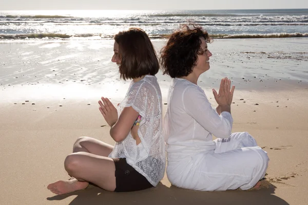 Serenity, zen, and Yoga on the beach for two girls