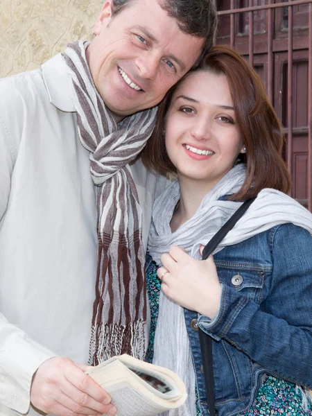 Man and woman on the historic area with a guide book