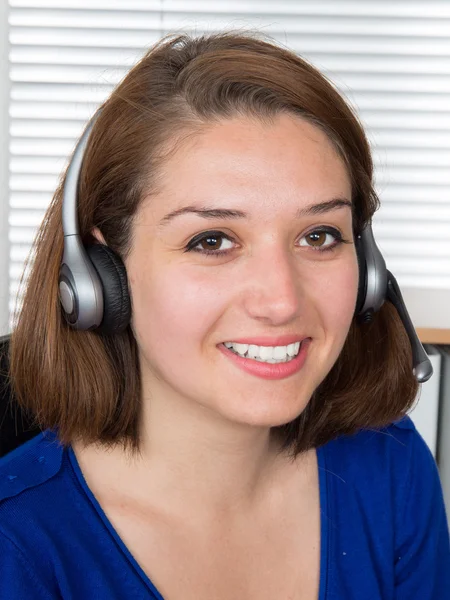 Female customer support operator with headset and smiling