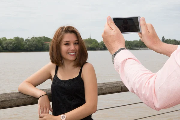 Man taking photos with his mobile of a woman