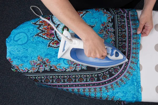 Bright picture of lovely housewife with iron , flat lay