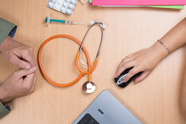 Doctor sitting at office desk and receiving patient