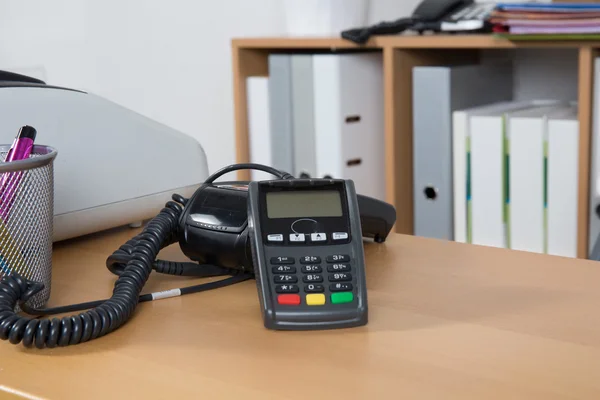 Credit card reader and cash register on background of store