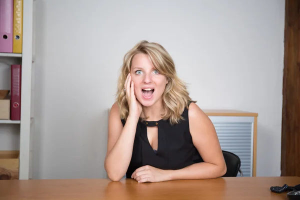 Close-up of a young woman looking surprised on white background