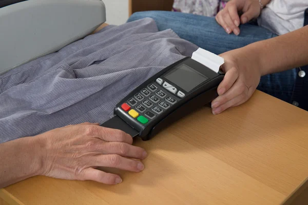 Hand push credit card into a credit card machine