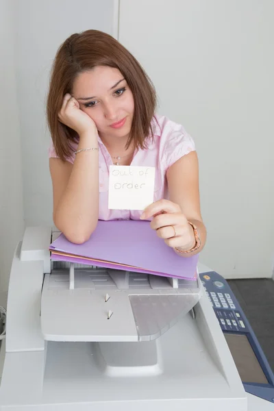 Businesswoman with copier thinking on the white background