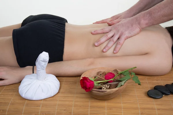 Young woman lying on a massage table and is being massaged