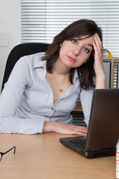 Picturet of an exhausted office worker at desk