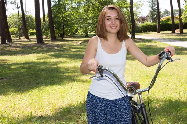 Portrait of Attractive Young Woman in blue shirt with cool beach cruiser