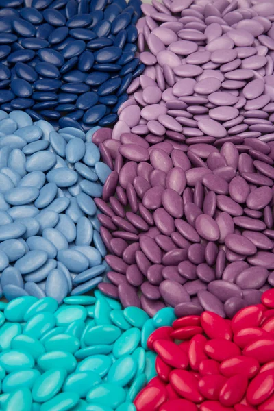 Colorful chocolate buttons, blue, purple and pink use for designer