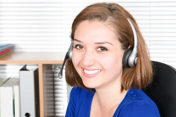 Woman customer support operator with headset and smiling