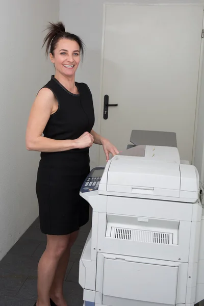 Woman at work, with a copy machine