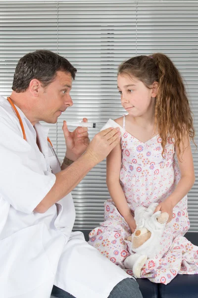 Male doctor with his little patient