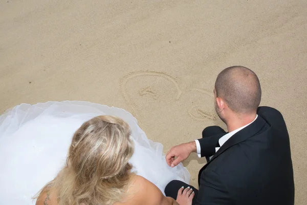 An attractive bride and groom getting married by the beach