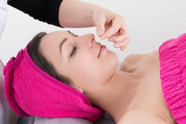 Acupuncture needles on head of a  woman at the spa tcm