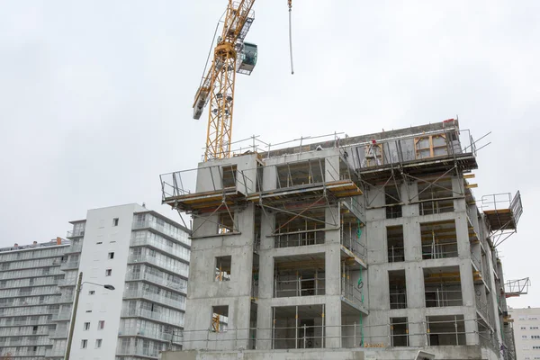 Inside place for many tall buildings under construction and cranes under a blue sky