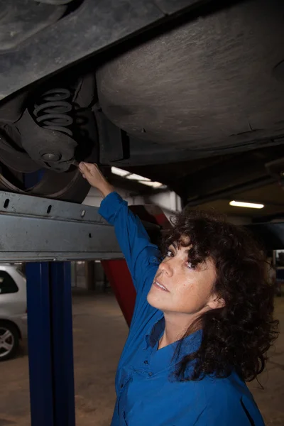 Female worker - Car mechanics repairing a car