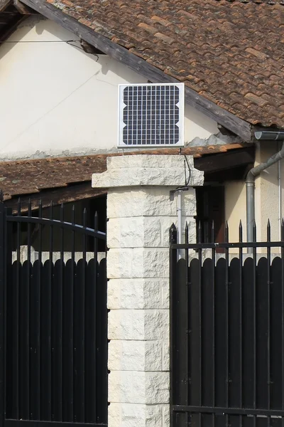 Solar panels on the gate of a private home.  Blue sky sunny summer day