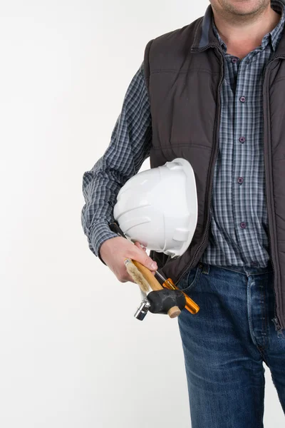 Man with tools in pocket and a construction helmet in hand against a plain white background.