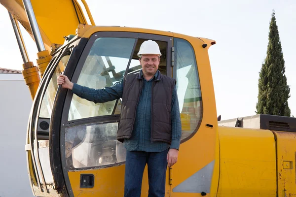 Happy and smiling construction worker with excavator
