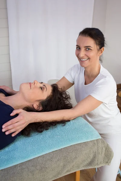 Beautiful brunette getting reiki therapy at the health spa