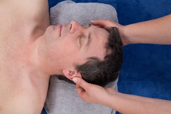 Spa man. Beautiful man Getting a Face Treatment at Beauty Salon. Face Massage