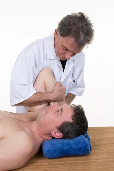 Male chiropractor doing neck adjustment in the medical office