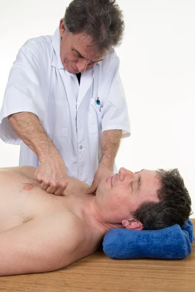Man receives a Bowen therapy, holistic system of healing