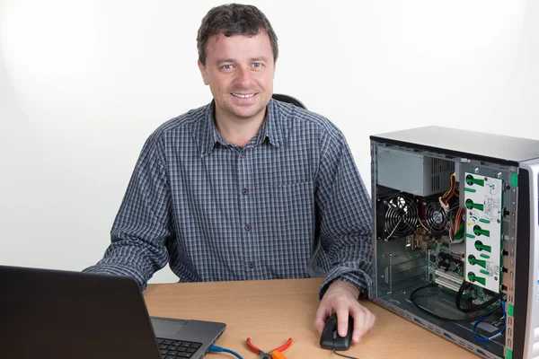 Technician male is fixing computer hardware at office