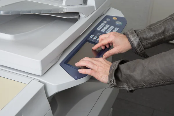 Woman\'s hand with working copy machine at office, good job