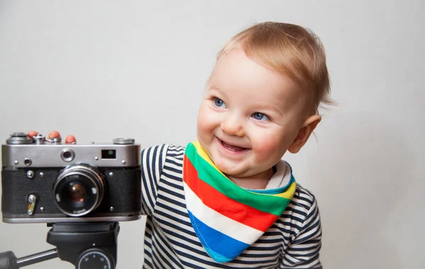 One year old baby boy with  camera
