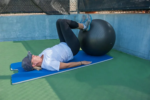 Supine leg curls on stability ball