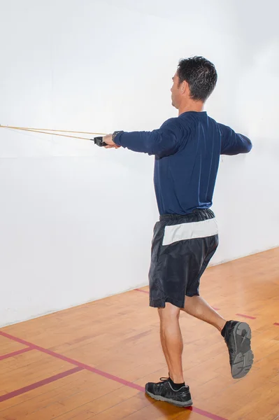Resistance band exercise for shoulders and balance.