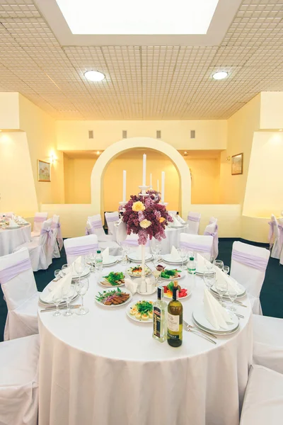 Covered banquet table in wedding restaurant