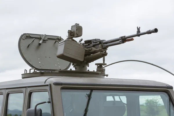 Military vehicle with heavy machine gun