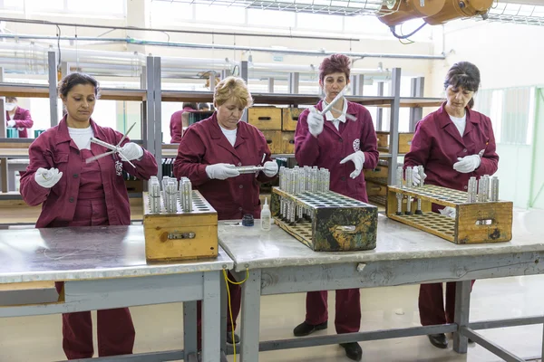 Workers at an assembly line in munition factory