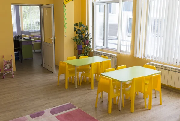Kindergarten classroom with small chairs and tables