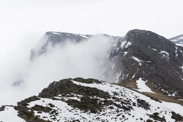 Rocky foggy mountain peak