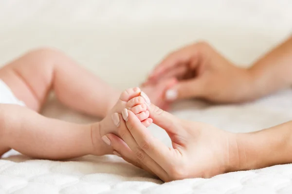 Massage cute feet of baby