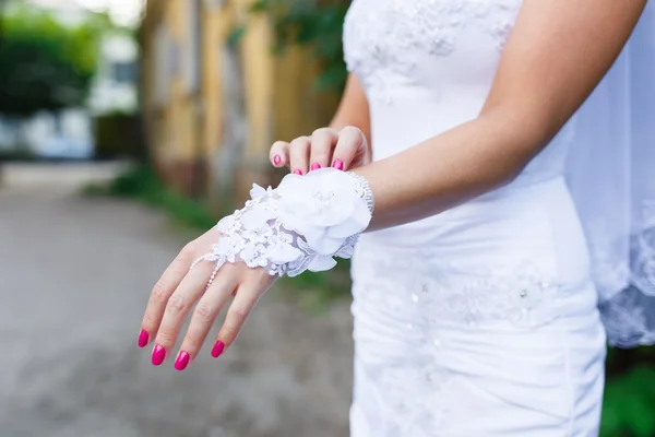 Bride dresses a white gloves