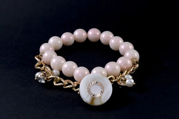 Bracelet with pearls and pendants isolated on white