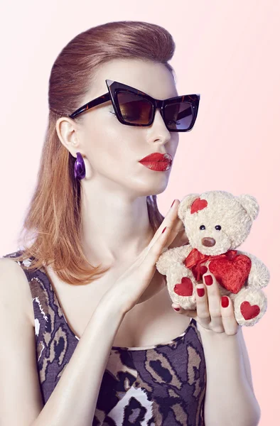 Portrait Fashion  girl in glasses, Loving teddy bear with red hearts