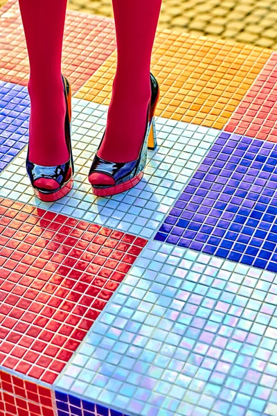 Fashion womens sexy legs, heels. Vivid multicolored geometry