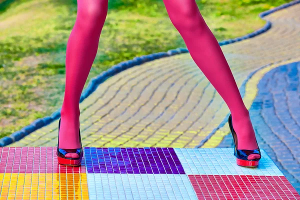 Fashion womens sexy legs, heels. Vivid multicolored geometry