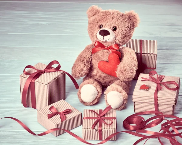 Valentines Day. Teddy Bear Love.Gift boxes on wood