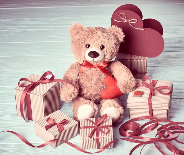 Valentines Day. Teddy Bear Love.Gift boxes on wood