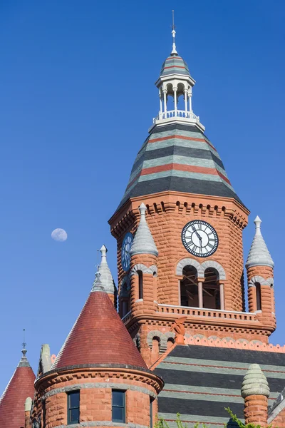 Moon over the clock tower of Old Red Museum in Dallas,  Texas